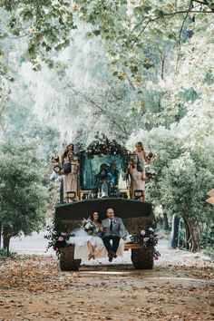 a bride and groom are sitting on the back of a tractor