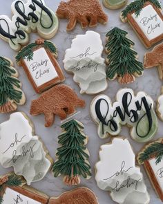 decorated cookies with trees, bears and names on them are displayed for the guests to eat