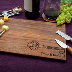 a wooden cutting board with cheese and wine on it