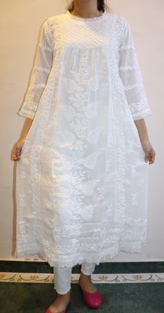 Personifying Grace and Elegance, our Muslin Victoria Dress with ruffle inserts on the neck,sleeves and hem is intricately embroidered in chikankari by our skilled artisans. Muslin adds flavour and comfort to this dress with its softness and fluidity. Inclusive with matching inner (lining) This Dress is dyeable. Length stands at 47/48 inches Available in sizes : XS - bust 34 S - bust 36 M - bust 38 L - bust 40 XL - bust 42 0X - bust 44 Spring Straight Kurta Dress With Lace Work, Spring Straight Kurta With Lace Work, Traditional Summer Dress With Cutwork, White Cutwork Dress For Eid, White Cutwork Dress For Festive Occasions, Festive White Dress With Cutwork, Festive White Cutwork Dress, Festive Lace Dress With Chikankari Embroidery, Cotton Anarkali Dress With Lace Work