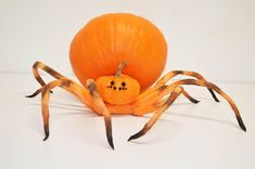 a pumpkin shaped like a spider sitting on top of a table