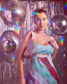 a woman standing in front of disco balls