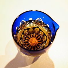 a blue glass bowl sitting on top of a table