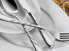 two forks and spoons sitting on top of a white plate