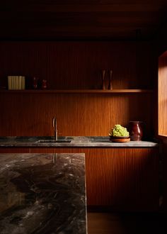 a kitchen counter with a bowl of grapes on it