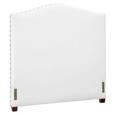 a white headboard with wooden legs and studding on the top, against a white background