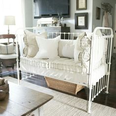 a living room with a white couch and some pictures on the wall