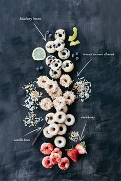 an assortment of donuts and fruits on a black surface with the words written above them