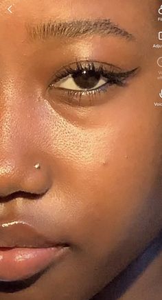 a close up of a woman's face with her eyeliners and eyebrows