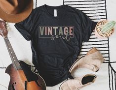 "Bring a touch of nostalgia to your wardrobe with this stylish \"Vintage Soul\" retro t-shirt. Perfect for those who appreciate vintage fashion and have a unique sense of style. This is a great gift for your best friend, mom, sister or any woman who loves vintage style. Made from high-quality cotton, this Bella + Canvas tee is comfortable, durable and perfect for everyday wear. Show off your vintage soul with this unique t-shirt today! This classic unisex jersey short sleeve tee fits like a well-loved favorite. Soft cotton and quality print make users fall in love with it over and over again. These t-shirts have-ribbed knit collars to bolster shaping. The shoulders have taping for better fit over time. Dual side seams hold the garment's shape for longer.  -100% Airlume combed and ringspun Vintage Soft-washed Short Sleeve T-shirt, Retro Black Soft-washed T-shirt, Vintage Cropped T-shirt For Summer, Vintage Text Print T-shirt, Vintage Soul, Unique T Shirt, Retro T Shirt, Bella Canvas Tees, Old Soul