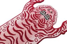 a red and white rug with a large tiger on it's face, in the shape of a lion