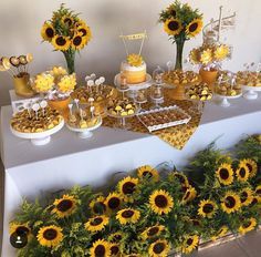 a table topped with lots of desserts and sunflowers