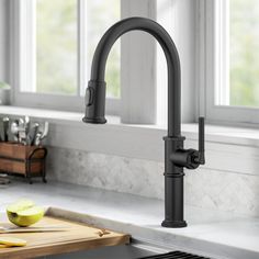 a kitchen sink with a black faucet and wooden cutting board on the counter