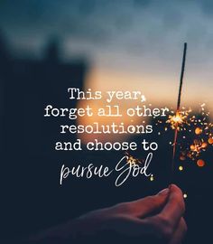 someone holding a sparkler with the words, this year forget all other resolutions and choose to pursue god