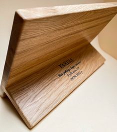 a wooden business card holder sitting on top of a table