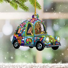 a car ornament hanging from a christmas tree