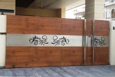 an image of a wooden gate with metal designs on the top and bottom paneling