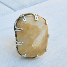 "Yellow quartzite beach gem from Maidstone Beach in East Hampton. The stone came here with the last ice age glaciers! It is set in a \"crown\" setting on a silver ring. Size is 6.5 US but it can be enlarged. The stone measures about 1.5 x 1 x 0.5 inches. For the beach lover in you!" Citrine Ring With Large Stone, Unique Adjustable Moonstone Ring With Large Stone, Large Round Citrine Stone Jewelry, Large Stone Citrine Jewelry For Anniversary, Adjustable Large Stone Moonstone Ring In Sterling Silver, Round Citrine Jewelry With Large Stone, Agate Jewelry With Large Stone For Anniversary, Adjustable Sterling Silver Moonstone Ring With Large Stone, Citrine Jewelry With Large Stone For Anniversary