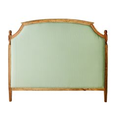 the headboard is made from wood and has green fabric