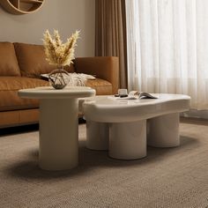 a living room with a couch, coffee table and clock on the wall above it