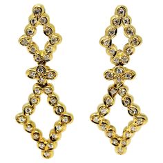 Brilliant diamond drop earrings set in 18 karat yellow gold. Featuring a double open diamond shaped arrangement, these super sparkly stunners dangle gently and glimmer from all angles. The elongated shape offers a flattering feminine fit, while the hollow design keeps the sizeable pair light and comfortable on the ear. These gorgeous earrings feature 1.20 carats total of sparkling white diamonds bezel set in polished 18 karat yellow gold. There are 2 hollow diamond shaped pieces, set in a vertic Gold Diamond Drop Earrings, Warm Yellow, Yellow Gold Setting, Diamond Drops, Diamond Shaped, Bezel Diamond, Diamond Drop Earrings, Brilliant Diamond, Gorgeous Earrings