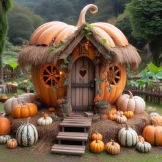 pumpkins and hay bales are arranged around a small house made out of straw