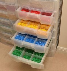 plastic storage bins filled with different colored legos