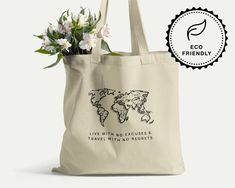 "This eco-friendly canvas tote bag will become your new favorite travel companion. Especially for eco-conscious world travelers. This durable shoulder bag is made of 100% certified organic cotton and comes with a unique hand-drawn world map line art and the inspirational phrase \"Live with no excuses and travel with no regrets\". The strong material is suitable to carry books or groceries and is the perfect daily companion. TOTE BAG  *  DETAILS There's nothing trendier than being eco-conscious! Eco-friendly Rectangular Canvas Travel Bag, Eco-friendly Canvas Bag For Weekend Trips, Reusable Canvas Travel Bags, Rectangular Reusable Canvas Travel Bag, Reusable Rectangular Canvas Travel Bag, Eco-friendly Ink Canvas Tote Bag For Travel, Eco-friendly Travel Canvas Gift Bag, Eco-friendly Canvas Travel Bag, Eco-friendly Travel Canvas Bag