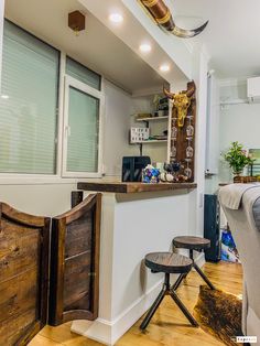 a living room filled with furniture next to a window