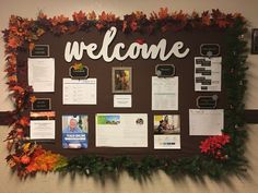 a bulletin board is decorated with fall leaves and welcome signs for the students to use