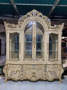 an ornate china cabinet with glass doors