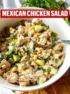 mexican chicken salad in a white bowl with tortilla chips