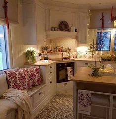 a kitchen filled with lots of counter space next to a sink and stove top oven