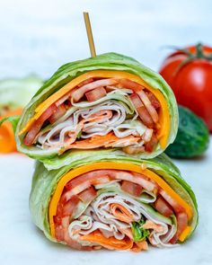 two wraps with meat and vegetables on the side