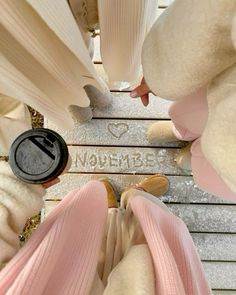 the bottom view of two people's feet wearing pink pants and shoes with words written on them