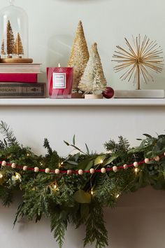 a christmas garland is hanging on the mantle