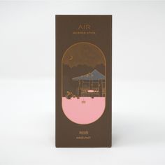 the back side of an air incense stick in pink and brown packaging on a white background