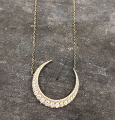 14 karat gold adjustable length crescent moon necklace. Pave and single diamonds, .68ct. Luxury Crescent Necklace For Anniversary, Luxury Crescent Necklace With Diamond Accents, Elegant Crescent Diamond Necklace, Fine Jewelry Crescent Necklaces With Single Cut Diamonds, Crescent Necklace With Single Cut Diamonds, Elegant Necklace With Moon Charm In Half Moon Shape, Elegant Half Moon Necklace With Moon Charm, Elegant Crescent Jewelry With Diamond Accents, Crescent Moon Phase Necklace For Wedding