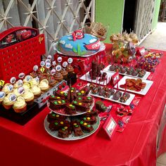 a red table topped with lots of desserts