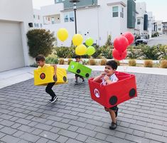 two young boys dressed up as cars and balloons