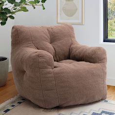 a brown bean bag chair sitting on top of a white floor