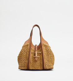 Shopping bag with flowing lines, crafted in raffia with fine crochet detailing and leather inserts. Characterized by the branded metal T Timeless pendant accessory, it comes with two fixed handles, adjustable and removable shoulder strap, internal pouch. Tote Crochet, Leather Zip Pouch, Tods Bag, Timeless Bags, Timeless Wardrobe Staples, Crochet Tote Bag, Woven Raffia, Raffia Bag, Crochet Tote