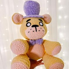 a crocheted teddy bear wearing a top hat