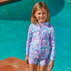 This girl’s half zipped ruched swim shirt is absolutely adorable and offers protection from 98% of the sun’s UV rays. Pair this girls swim shirt with our matching UV swim shorts and you have a fashionable sun-protective swimsuit she’ll love to play in year-round. Your little one will love the buttery soft, 4-way stretch fabric of this bathing suit, and you’ll love that you won’t need to keep reapplying sunscreen on her all day long. Shop it in a variety of fun prints. Summer Rash Guard With Uv Protection, Summer Rash Guard With Uv Protection For Swimming, Spring Poolside Rash Guard With Uv Protection, Upf 50+ Swim Trunks For Beachwear, Spring Rash Guard With Uv Protection For Poolside, Casual Summer Rash Guard For Pool, Casual Rash Guard For Pool In Summer, Long Sleeve Rash Guard With Uv Protection For Playwear, Summer Rash Guard With Upf 50+ For Poolside