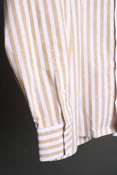 A bespoke shirt crafted from a textured cotton blend fabric in an oversized candy stripe. The larger striped pattern gives it a punch of style, making it a great casual shirt that can be worn with chinos or jeans - or under suits and jackets. The lightweight fabric drapes effortlessly, making it an ideal choice for those seeking a sophisticated yet relaxed look. Classic Striped Linen Tops, White Linen Top With Vertical Stripes, Striped Shirt With Relaxed Fit And Spread Collar, Cotton Tops With Vertical Stripes And Spread Collar, Striped Linen Tops For Work, Cotton Shirt With Striped Cuffs And Relaxed Fit, Bespoke Shirts, Suits And Jackets, Suit Shirts