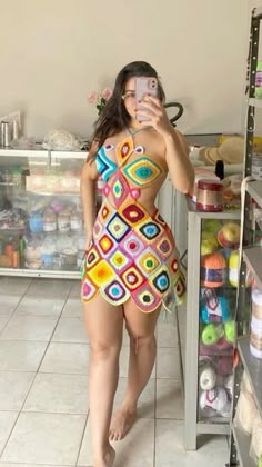 a woman taking a selfie in a colorful bathing suit