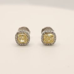 Beautiful yellow natural diamond cushion shape stud earrings. Main Stones: 2 cushion shape natural diamonds first stone: GIA certificate Weight: 0.63 ct Clarity - VS2 Color - Y-Z second stone: GIA certificate Weight: 0.61 ct Clarity - VVS1 Color - W-X Side Stones: 36 Round Shape Natural Diamonds In Weight Of 0.20Ct Clarity - Vs2 Color - F -Shipment made by FedEx/ DHL is fully insured and covered. -The ring shipped in a luxury and elegant box and bug -Certificate Of Authenticity Included By IGL lab Alena Diamonds & Jewelry was created from our passion for custom-made jewelry, and for fulfilling our customer's fantasies. We are Alex and Maayan, we created Alena after years of experience we received by working in the jewelry industry, Starting from diamond gemology in the Israeli diamond exch Cushion Cut Diamond Earrings With Halo Design, Luxury Gold Diamond Halo Earrings, Diamond Cushion Cut Halo Earrings, Cushion Cut Halo Diamond Earrings, Diamond Halo Design Cushion Cut Earrings, Cushion Cut Cubic Zirconia Earrings With Halo Design, Dazzling Gold Halo Diamond Earrings, Cushion Cut Diamond Halo Earrings, Formal Yellow Diamond Earrings With Halo Design