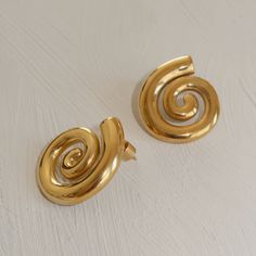 Description Spiral shaped earrings, lightweight and ready to wear. Material 18K Gold Plating includes Joiana 18k gold plated Signture Ear Backs How to care for your jewelry: Water resistant but always strongly recommend removing your jewelry before participating in any activities that can lead to contact with moisture or chemicals, such as washing your hands, sleeping in your jewelry, or showering, to maintain shine and ensure a long lifetime. Spiral Shape, Swirl Earrings, Silver Jewelry Earrings, Jewelry Lookbook, Contemporary Jewellery, Artistic Jewelry, Gold Plating, Chemicals, Gold Earrings