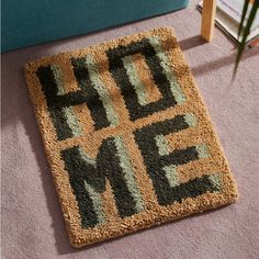 a rug that says hide me on the floor in front of a couch and bookshelf