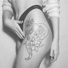 a woman's thigh with an elephant and flowers tattoo on her side, while the lower half of her leg is visible